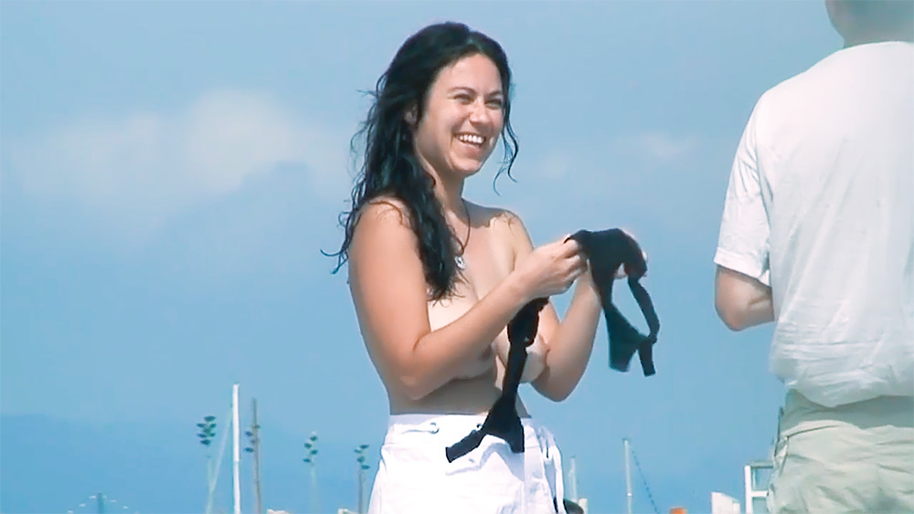 Two Women Topless on a Promenade by the Marina