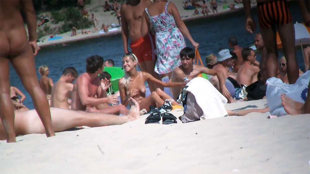 Six Naturists Gathered on a Sandy River Beach