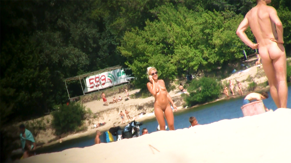 Sexy young nudist blonde caught on the beach on a hidden cam