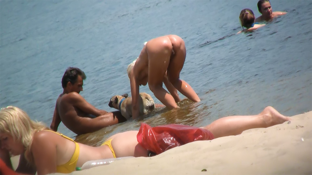Bending at the Shoreline on a Nude Beach