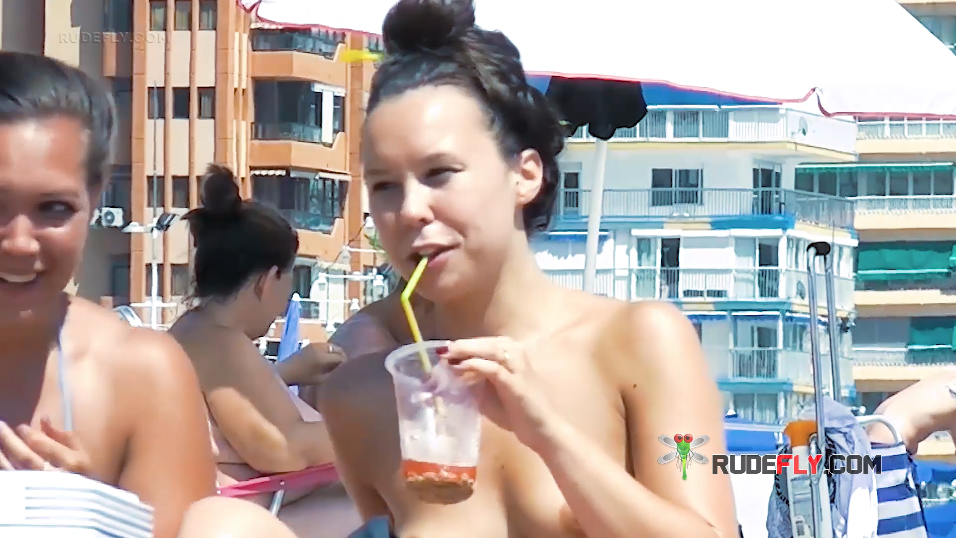 Serene Vacationers Reclining Sunbathing Topless on Ibiza Beach