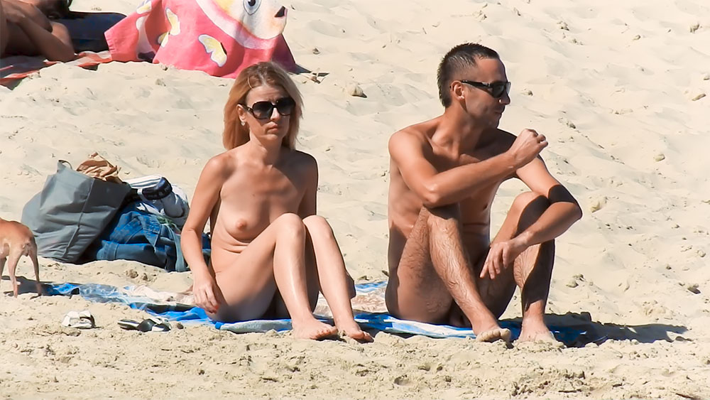 Two Nudists Sharing a Towel on Sandy Shore 1