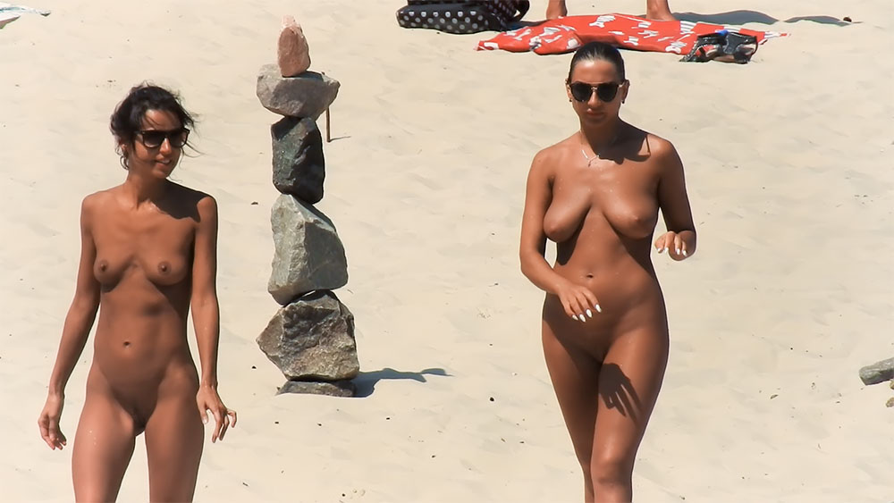 Walking Across the Sand at a Sunny Nude Beach