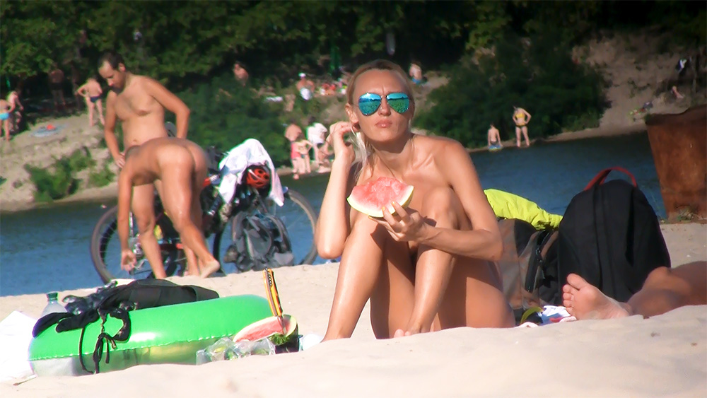 One Nude Beach Sunbather in Mirrored Blue Sunglasses