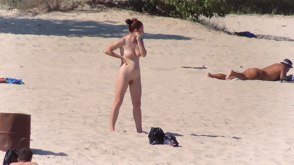 Dressing After Sunbathing on a Sandy Nudist Beach