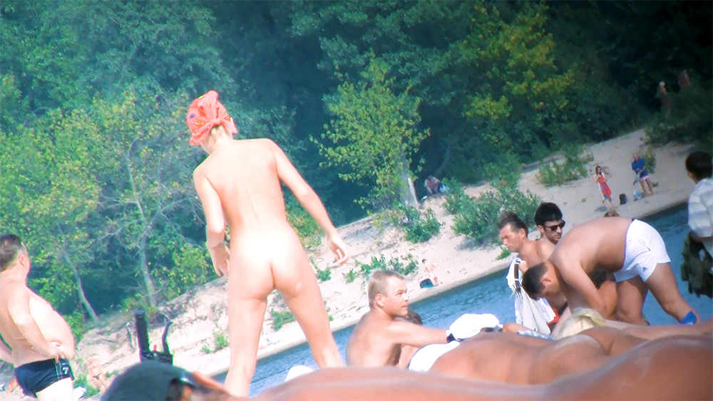 Standing at the Shoreline Among Riverbank Nudists