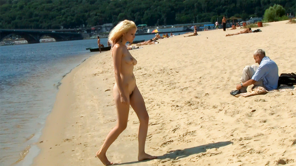 Walking Barefoot Across a Sandy Nude Beach Shoreline