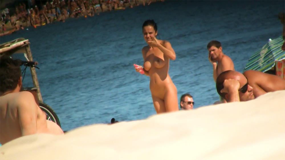 Four Nudists Gathered Near the Water's Edge