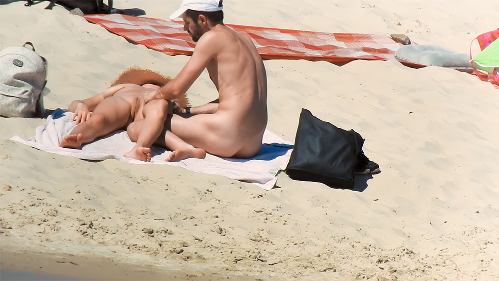 Nude Beach Couple Sitting Together on Sandy Towels