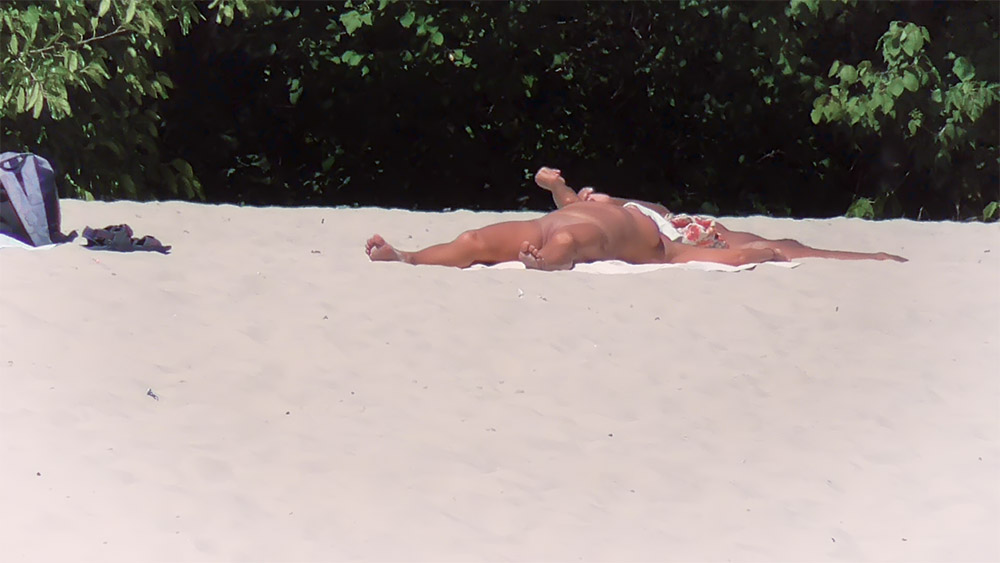 Floral Towel Sunbathing Spot on a Sandy Nude Beach