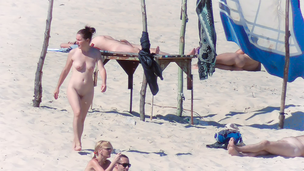 Walking Past Wooden Platforms on a Nude Beach
