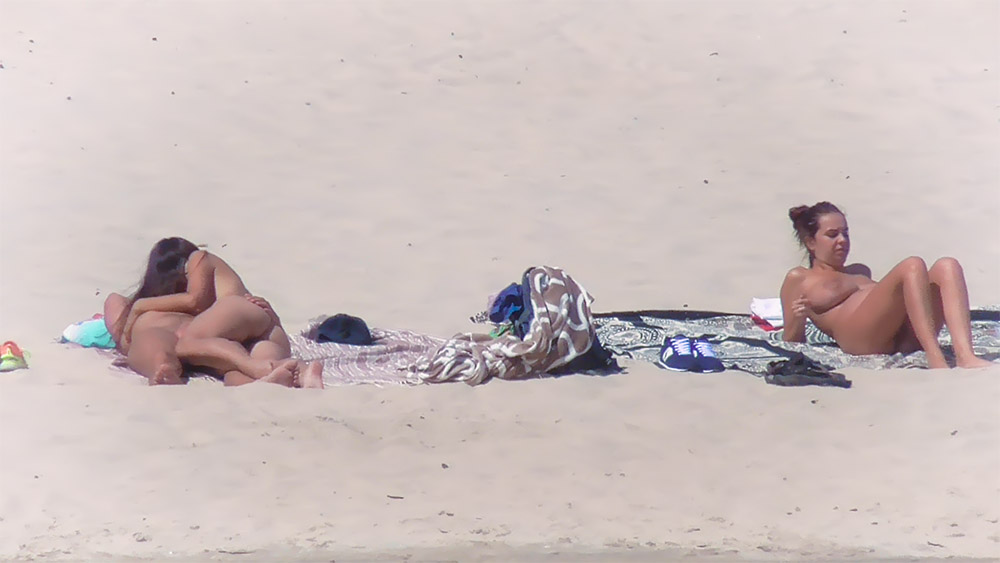 Nude Beach Lounger Resting Beside a Folded Towel