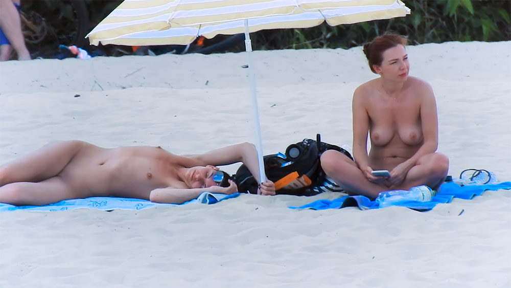 Blue Patterned Towel on Sand with Nude Beach Sunbather