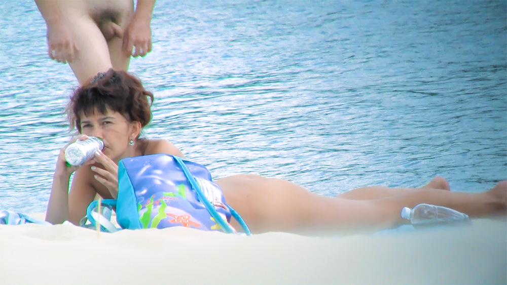 Beautiful nude beach girl secretly filmed by a voyeur enjoying a sunny day.