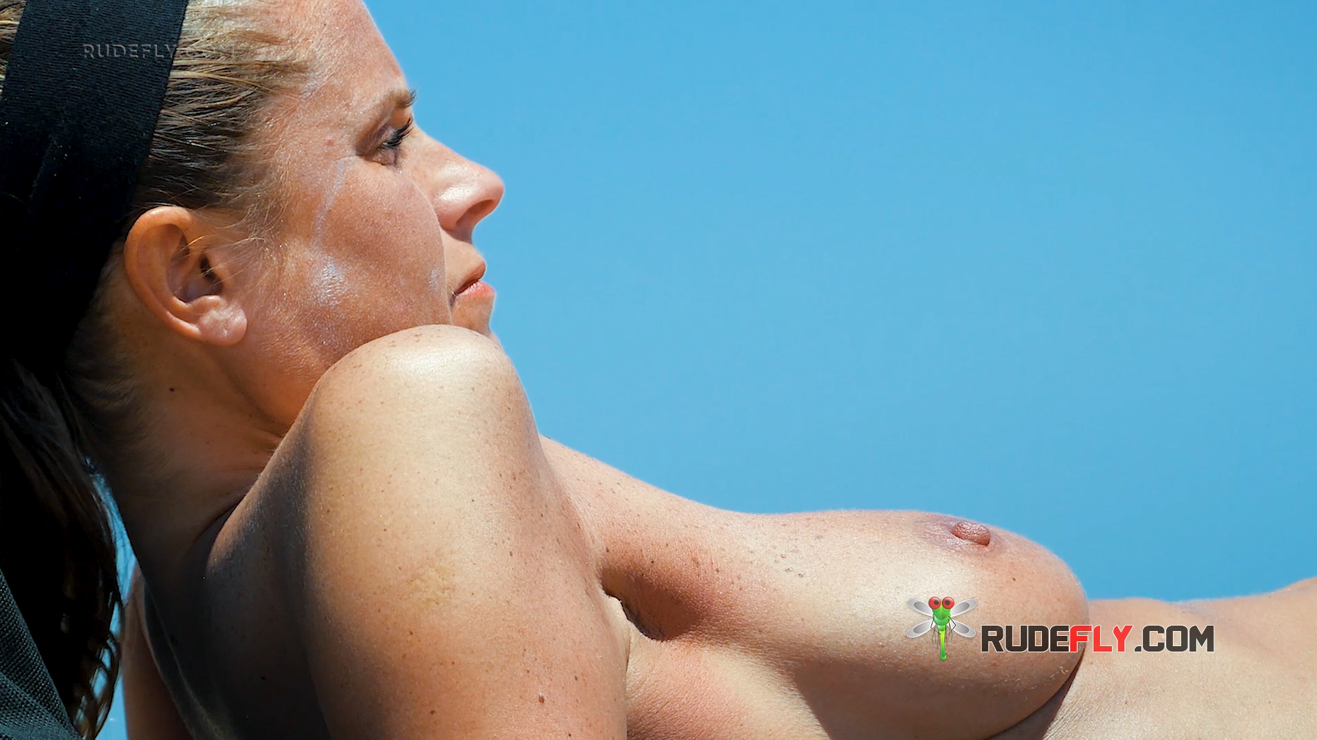 One Blonde Woman at a Topless Beach in Black Bikini