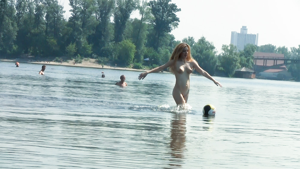 Wading Toward a Floating Ball at a Nudist Beach