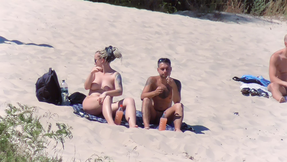 Nude Beach Couple Beside Pink Drink Bottles