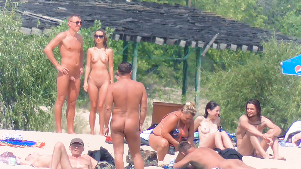 oung nudist chick fools around at the beach.