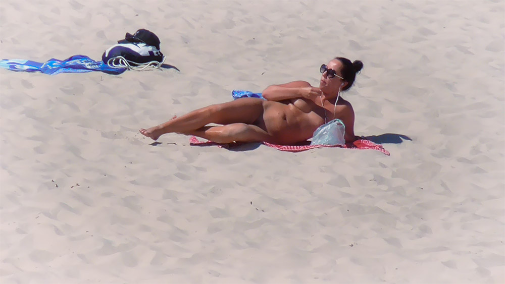Reclining on a Red Towel at the Topless Beach