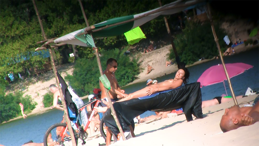 Naughty milf shows off her privates on the sand