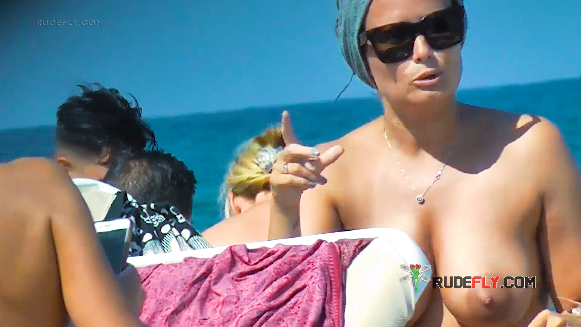 One Woman Topless on the Beach in a Grey Head Wrap