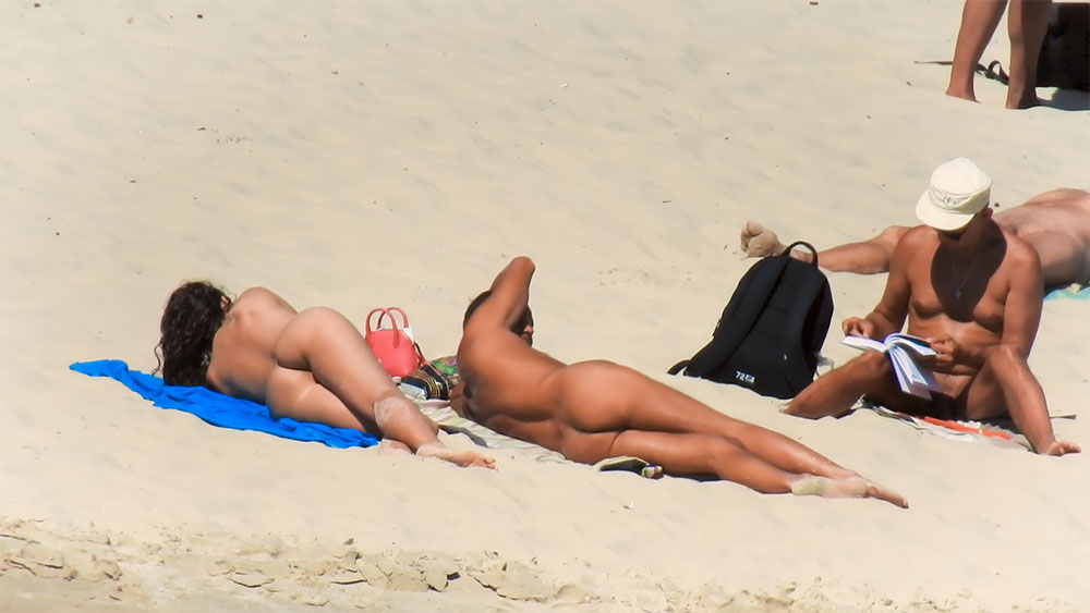 Sunbathing Prone on a Blue Towel at a Nude Beach