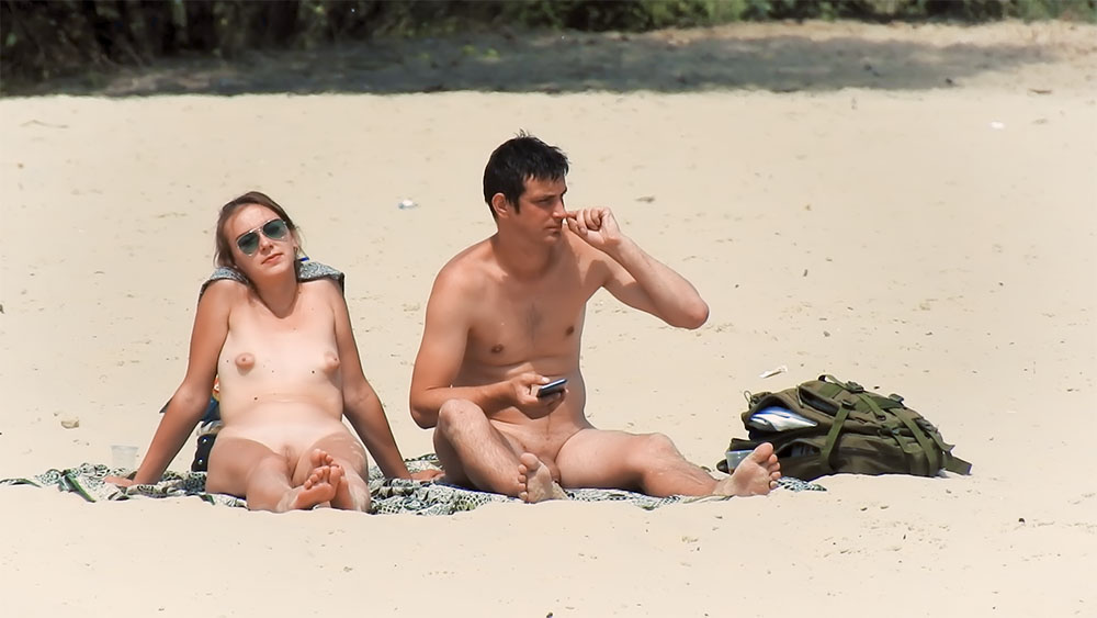 Sitting on a Towel at a Nude Beach in a Blue Cap