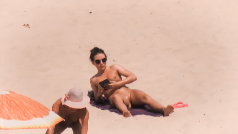 Purple Towel and Sunglasses on a Quiet Nudist Beach