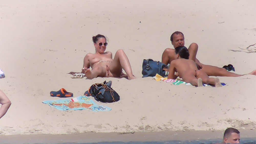 Nude Beach Bathers Gathered Around a Towel and Bags