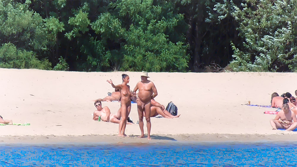 Five Nudists Gathered on a Quiet Nude Beach Shore