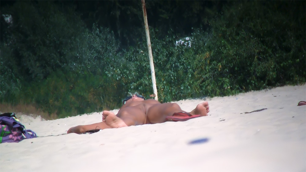 Sunbathing Face Down on the Sand at a Nude Beach
