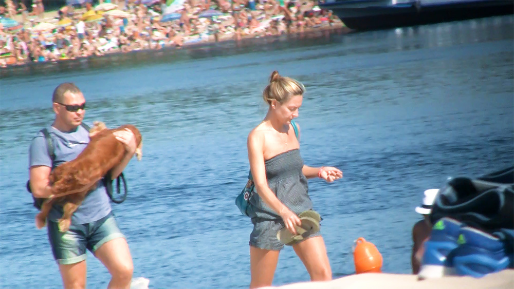Stepping Off a Boat at the Lake in a Grey Romper