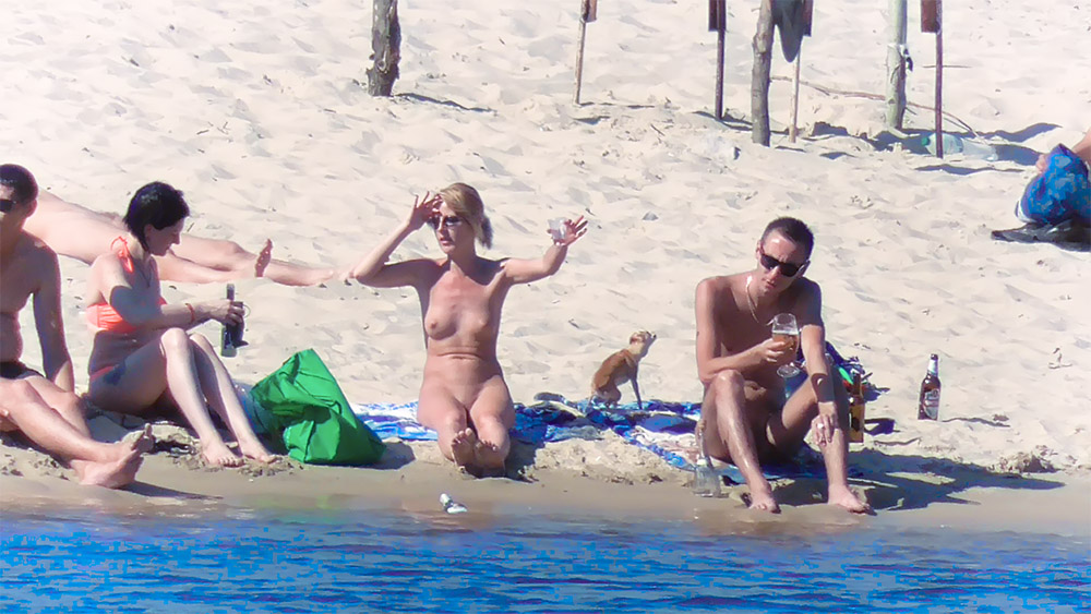 Two Women at a Nude Beach with a Green Towel