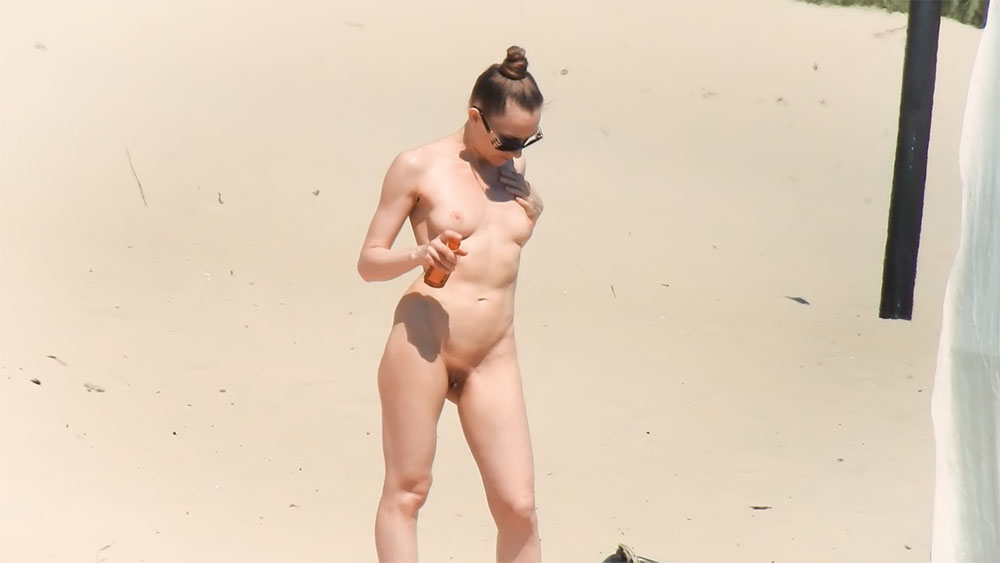 Applying Sunscreen While Standing on a Nude Beach