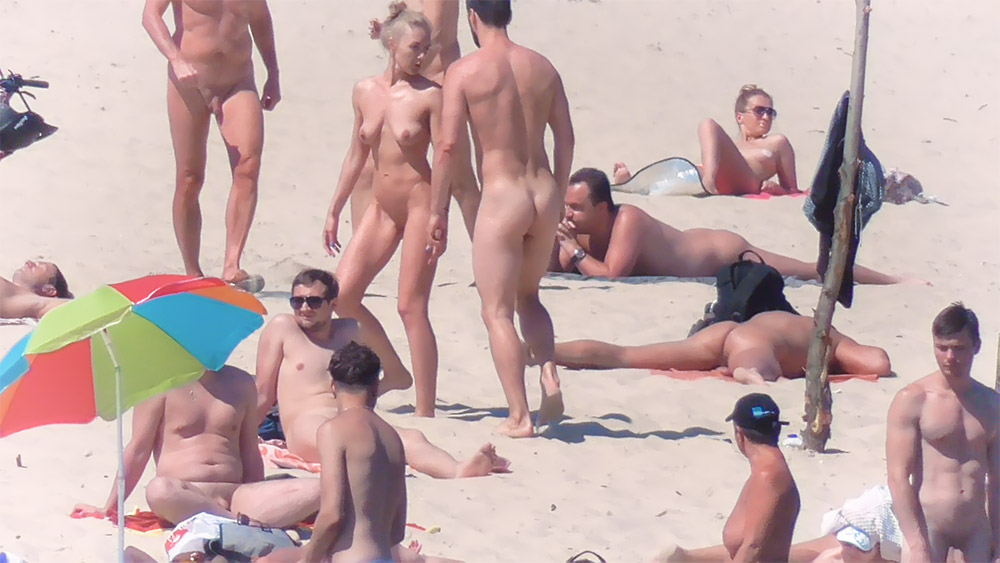 Skinny nude beach girl filmed on a video by a voyeur.