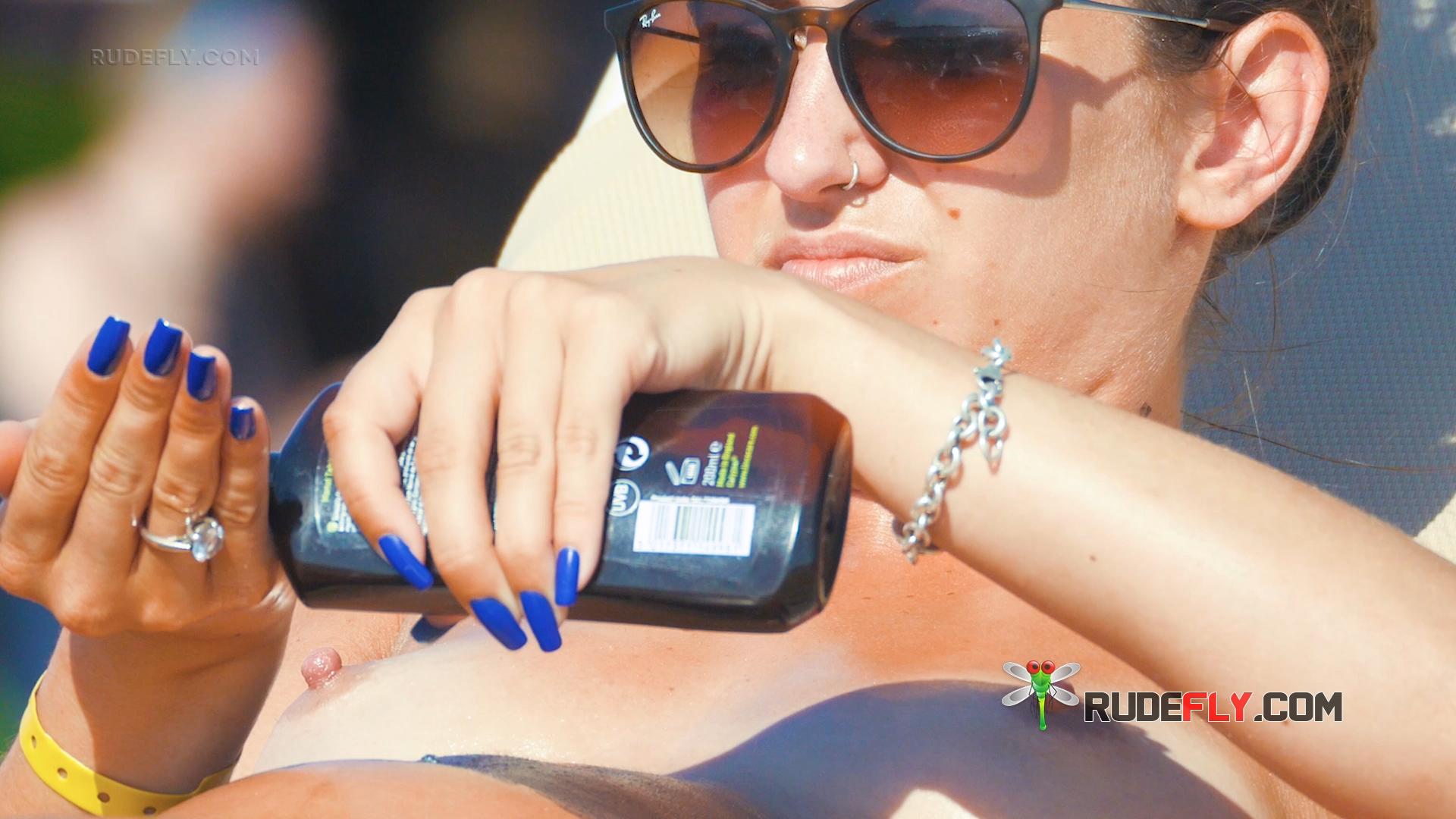 Blissful Women Chilling Out Sunbathing Topless on Andalusian Coast Beach