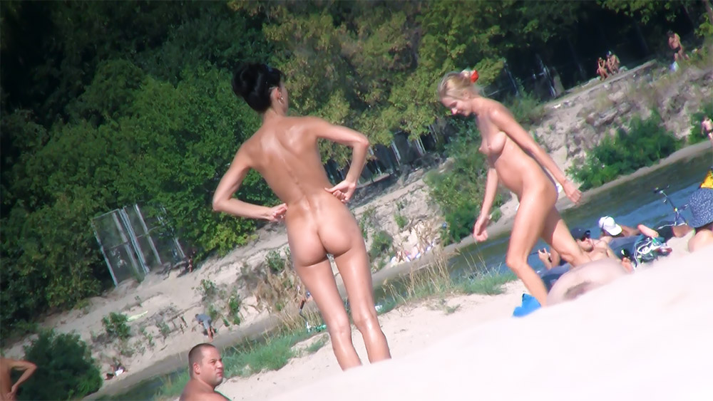 Rocky Shoreline Nude Beach with Two Women Standing