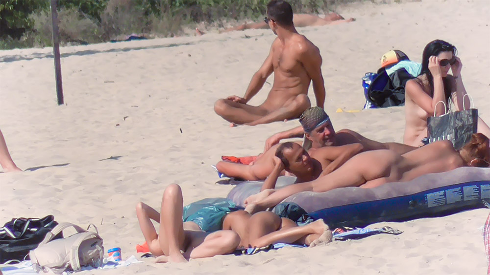 Five Nudists Settled on Sand with Air Loungers