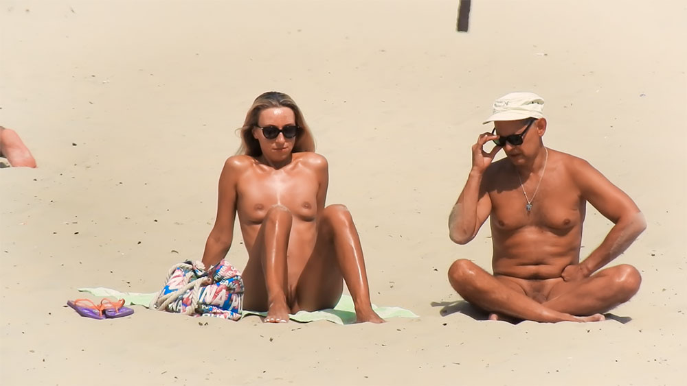 Sitting on a Towel at the Nude Beach in Sunglasses