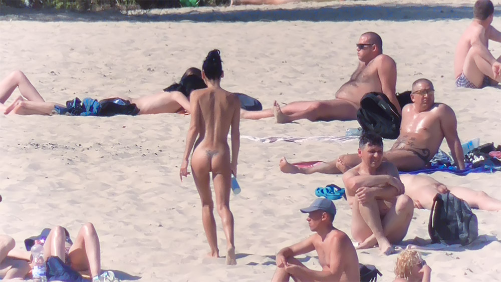 Sandy Nude Beach Stroll Among Resting Sunbathers