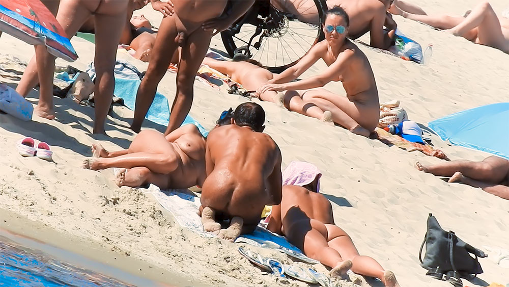 Stretching Toward Her Feet on a Nude Beach