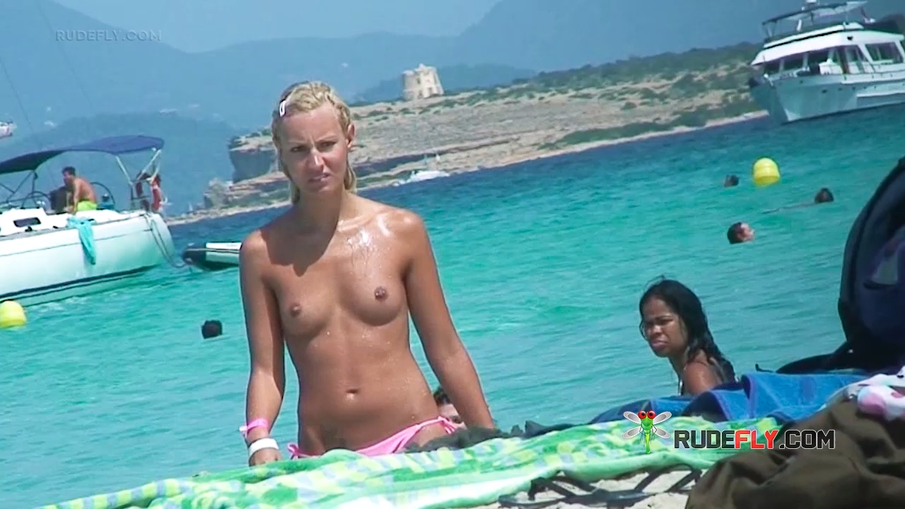 One Woman Topless on Beach Towel in Pink Bottoms