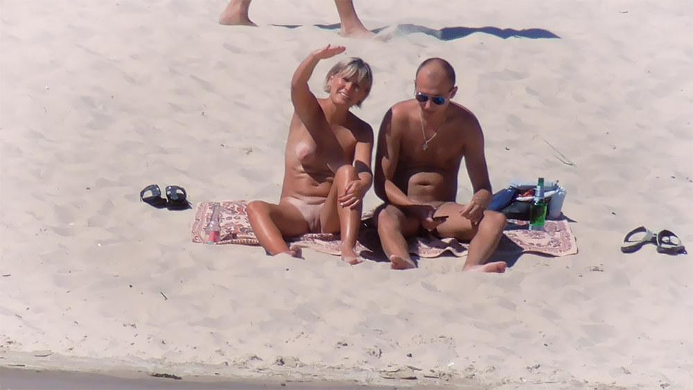 Nude Beach Couple Sitting on a Patterned Towel