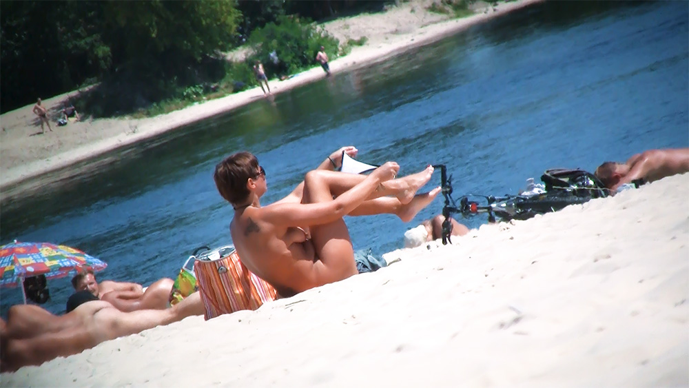 Reclining Nude Beach Sunbather on a Striped Orange Towel
