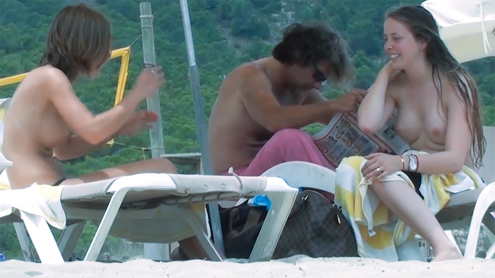 Energetic young nudist chicks secretly filmed having fun at the beach 2